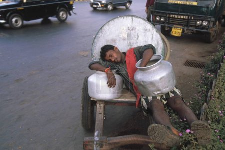 Photo for Siesta time, man sleeping on his cart - Royalty Free Image
