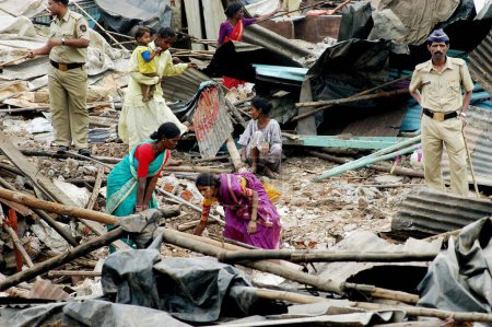 Téléchargez les photos : Les habitants des bidonvilles retirent leurs biens après la démolition de bidonvilles illégaux sur la route Mankhurd Link à Bombay maintenant Mumbai, Maharashtra, Inde - en image libre de droit