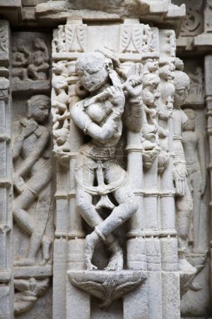 Sculptures of female musician playing flute in dancing pose ; 2000 years old Adinath Jain temple ; Village Delwara ; Udaipur ; Rajasthan ; India