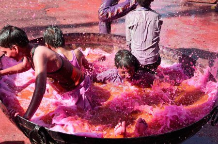 Photo for Boys enjoying colourful water Holi Rajasthan India Asia - Royalty Free Image