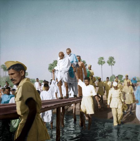 Photo for Mahatma Gandhi with Abdul Ghaffar Khan crossing bridge, Bihar, India, March 1947 - Royalty Free Image