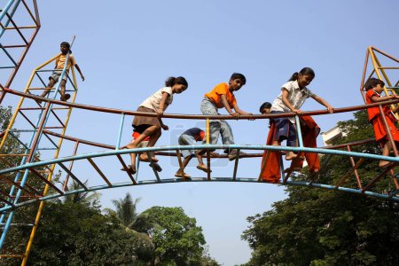 Photo for Children playing on rod tower, mumbai, maharashtra, india, asia - Royalty Free Image