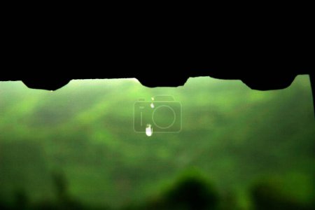 Photo for Conceptual image of drops of water falling from roof - Royalty Free Image