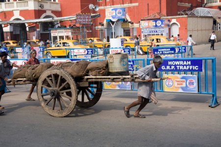 Foto de Hombre tirando del carro cerca de la estación de tren Howrah; Escena de la calle; Calcuta Kolkata; Bengala Occidental; India - Imagen libre de derechos