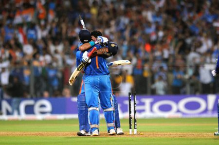 Photo for Indian cricket captain Mahendra Singh Dhoni R and team mate Yuvraj Singh celebrate after beating Sri Lanka during the ICC Cricket World Cup 2011 final match at The Wankhede Stadium in Mumbai on April 2 2011 India beat Sri Lanka by six wickets - Royalty Free Image