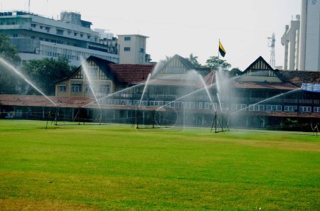 Water sprinklers sprinkling over ground at Mumbai gymkhana ; Bombay Mumbai ; Maharashtra ; India