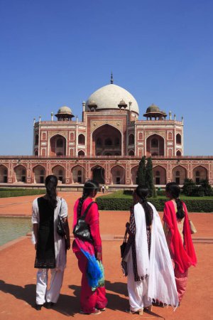 Indian girls watching Humayun's tomb built in 1570 made from red sandstone and white marble first garden-tomb on Indian subcontinent persian influence in mughal architecture , Delhi, India UNESCO World Heritage Site