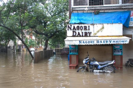 Photo for Floods due to heavy rain, Monsoon, in Mumbai Bombay, Maharashtra, India, pictures shot on 27th july2005 in Mira road. Record 944mm rainfall in the city,  Water logging in the residential colony, Black passion motorbike, Market - Royalty Free Image