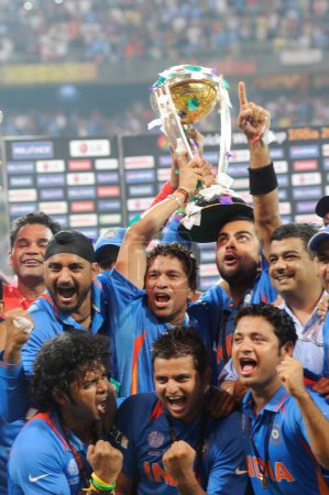 Photo for Indian cricketer Sachin Tendulkar c celebrate with the ICC World cup trophy after beating Sri Lanka in the ICC Cricket World Cup 2011 final match at The Wankhede Stadium in Mumbai on April 2 2011 India defeated Sri Lanka by six wickets - Royalty Free Image
