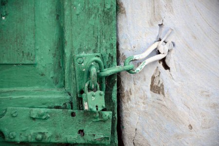 Photo for Locked green wooden door with blue wall house, jodhpur, rajasthan, india, asia - Royalty Free Image