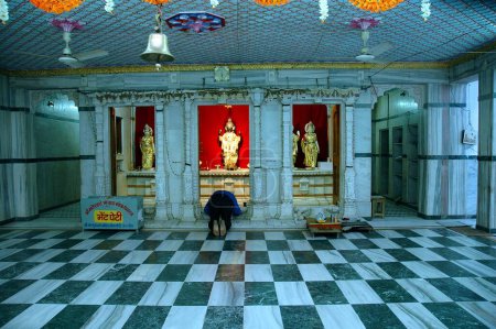 Photo for Indian pilgrim praying at Hindu temple, Ujjain, Madhya Pradesh, India - Royalty Free Image
