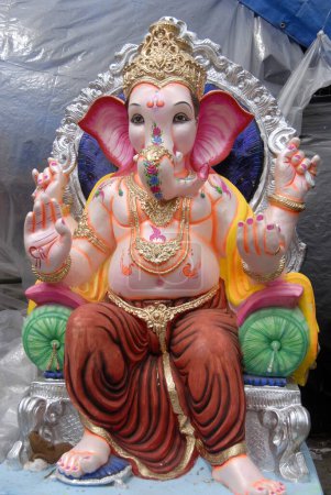Idol of Lord Ganesh ganpati sitting on throne for sale during Ganesh festival at Dadar ; Mumbai Bombay ; Maharashtra ; India