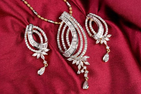 Diamond jewelry placed on cloth with earrings diamond pendant, diamond jewellery 