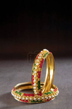 Photo for Artificial Gold Bangles on black background - Royalty Free Image