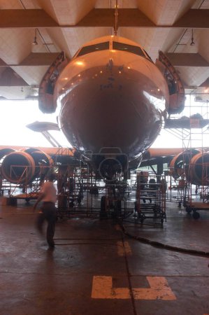 Photo for Aeroplane, An Indian Airlines aircraft undergoing repairs at the domestic airport workshop at Santacruz, in the western suburb in Bombay, now Mumbai city, Maharashtra, India - Royalty Free Image