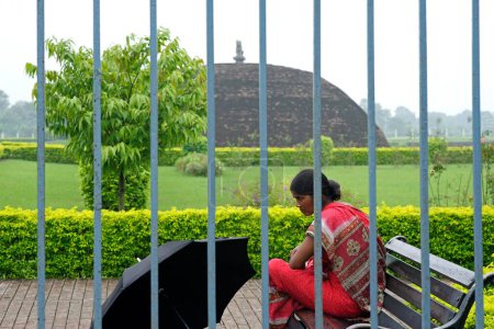 Photo for Woman sitting ; Buddhist site ; Ashoka pillar ; Kolhua Vaishali ; Bihar ; India - Royalty Free Image