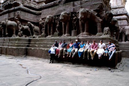 Photo for Group of tourists sitting at Kailash temple at Ellora caves, Aurangabad, Maharashtra, India - Royalty Free Image