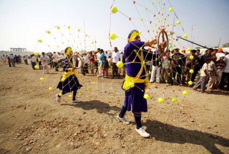 Photo for Young Nihangs or Sikh warriors performing a traditional martial art called Gatka during the cultural events held for celebrations of 300th year of consecration of perpetual Guru Granth Sahib, Nanded, Maharashtra, India - Royalty Free Image