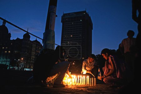 Photo for People lighting candles homage to victims after terrorist attack by deccan mujahedeen in Bombay Mumbai, Maharashtra, India 1,December,2008 - Royalty Free Image