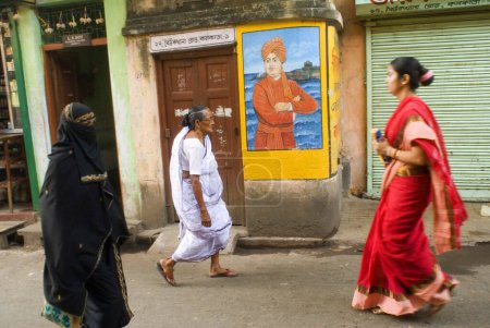 Photo for People walking in front of Swami Vivekananda Wall paining; Kolkata ; West Bengal ; India - Royalty Free Image