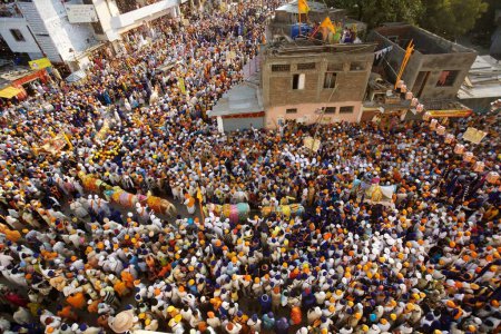 Photo for Sikh devotees taking part in procession at the Sachkhand Saheb Gurudwara for 300th year of Consecration of perpetual Guru Granth Sahib on 30th October 2008, Nanded, Maharashtra, India - Royalty Free Image