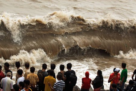 Photo for People enjoying hightide waves at marine drive Bombay , Mumbai , Maharashtra , India - Royalty Free Image