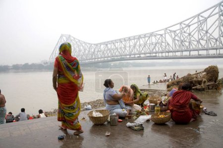 Téléchargez les photos : Activités sur le ghat de Babu ; pont Howrah au-dessus de Hooween rivière en arrière-plan ; Calcutta maintenant Kolkata ; Bengale occidental ; Inde - en image libre de droit