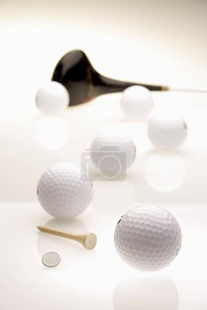 Golf balls six with golf club, marker tee