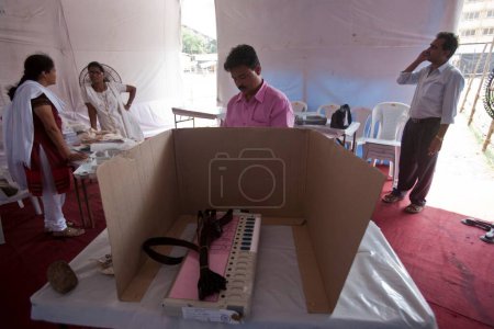 Photo for Election officer setting up electronic voting machine, maharashtra, india, asia - Royalty Free Image