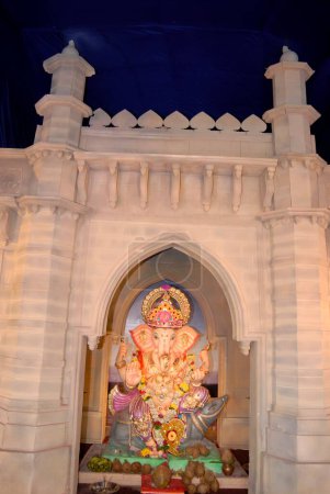 Téléchargez les photos : Idole colorée de Lord Ganesh avec décoration de réplique de la porte d'entrée de l'Inde ; adoration pour le festival Ganapati ; dieu tête d'éléphant de l'hindou ; Pratiksha Nagar ; Sion ; Mumbai Bombay ; Inde - en image libre de droit