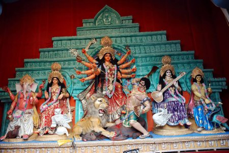 Foto de Modelo de arcilla Durga matando mahishasura demonio con estatuas de kartikeya ganesha y lakshmi saraswati en Durga puja - Imagen libre de derechos
