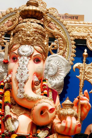 Huge idol of lord Ganesh ganpati elephant headed god being paraded in immersion ; Pune; Maharashtra ; India