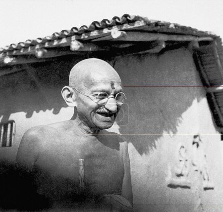 Foto de Mahatma Gandhi frente a su cabaña en el Ashram Sevagram, 1942 - Imagen libre de derechos