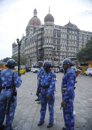 Photo for Rapid Action Force RAF commandos in front of Taj Mahal hotel ; after terrorist attack by Deccan Mujahedeen on 26th November 2008 in Bombay Mumbai ; Maharashtra ; India - Royalty Free Image