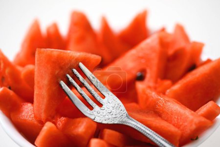 Photo for Fruits , Water Melon Latin Citrullus Lanatus cut pieces in bowl with fork - Royalty Free Image