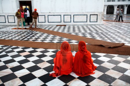 Photo for Girls sitting at Guru Tegh Bahadur sahib Gurudwara at Baba Bakala, Amritsar, Punjab, India - Royalty Free Image