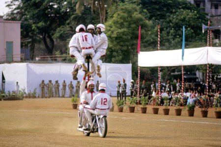 Téléchargez les photos : Motocyclistes performant au sol, Inde - en image libre de droit