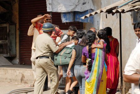Téléchargez les photos : Des policiers conduisent des écoliers dans des lieux sûrs après que la communauté dalit ait eu recours à des manifestations violentes, Bombay maintenant Mumbai, Maharashtra, Inde - en image libre de droit