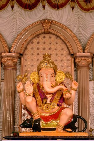 Richly decorated idol of Lord Ganesh sitting on mouse ; elephant headed God of Hindu worshiping for Ganapati festival ; Guruji Talim Mandal ; Ganapati Chowk ; third in honour at Pune ; Maharashtra ; India