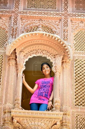 Girl standing in window Mehrangarh Fort Jodhpur Rajasthan India Asia MR#704
