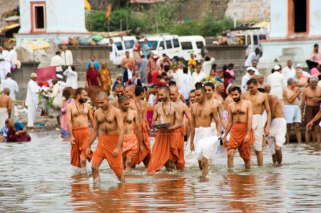 Photo for Sectarian doing religious rites in river chandrabhaga at ; Pandharpur ; district Solapur ; Maharashtra ; India NO MR - Royalty Free Image