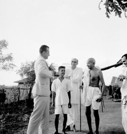 Photo for Mahatma Gandhi with co-workers and a visitor from USA at Sevagram Ashram, Vardha, Maharashtra, India, 1940 - Royalty Free Image