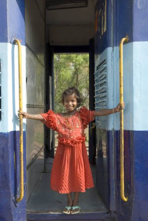 Foto de Niña parada en la puerta del tren de pasajeros; Manikpur; Uttar pradesh; India - Imagen libre de derechos