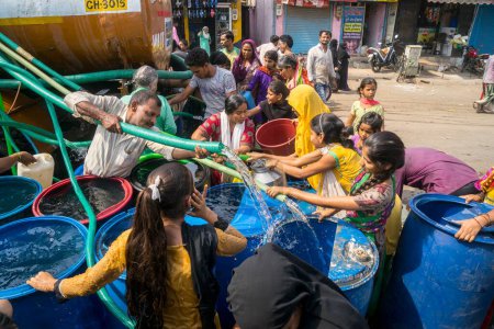 Photo for People filling water in plastic drums from water tanker, Bhiwandi, Maharashtra, India - Royalty Free Image