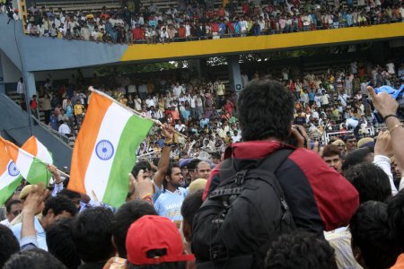 Photo for Cricket fans wave tri color Indian flag at Wankhede Stadium during victory procession of Twenty 20 team, Bombay Mumbai, Maharashtra, India - Royalty Free Image