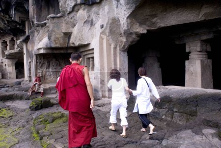 Photo for Buddhist monk and tourists at Ellora caves, Aurangabad, Maharashtra, India - Royalty Free Image