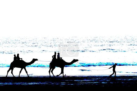 Photo for Tourists enjoying Camel ride at sunset with sparkling water of Arabian sea, Ganapatipule Beach, southern Konkan coast, District Ratnagiri, Maharashtra, India - Royalty Free Image