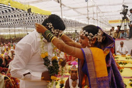 Photo for Couples getting married at mass marriage function organized by Sant Nirankari Mission at Airoli, New Bombay now Navi Mumbai, Maharashtra, India - Royalty Free Image