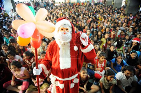 Photo for Santa claus coming around children, Bombay Mumbai, Maharashtra, India - Royalty Free Image