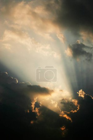 Photo for Sunrays piercing through clouds just after sunrise ; Pune ; Maharashtra ; India - Royalty Free Image